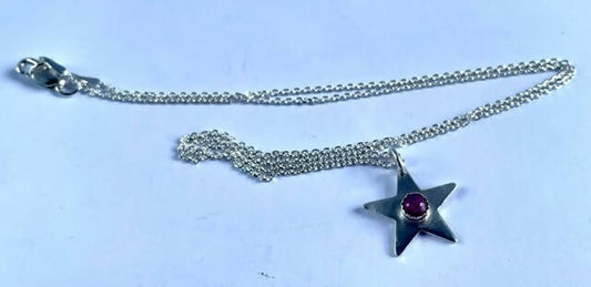 Sterling silver star with ruby cabochon